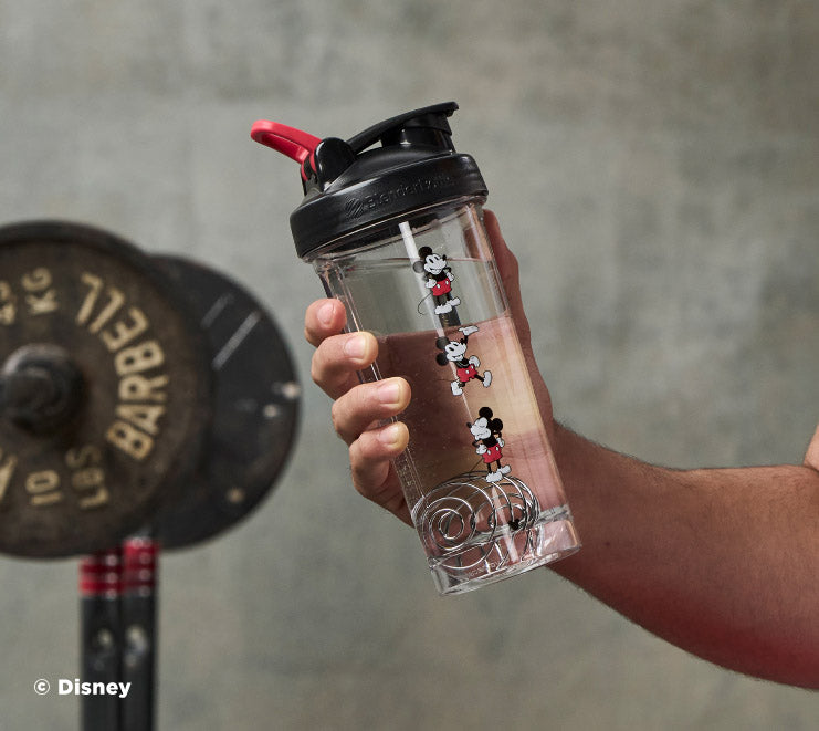 pro-series-n6 Mickey_Mouse_Protein_Shaker_Bottle_Being_Held_In_the_Gym.jpg